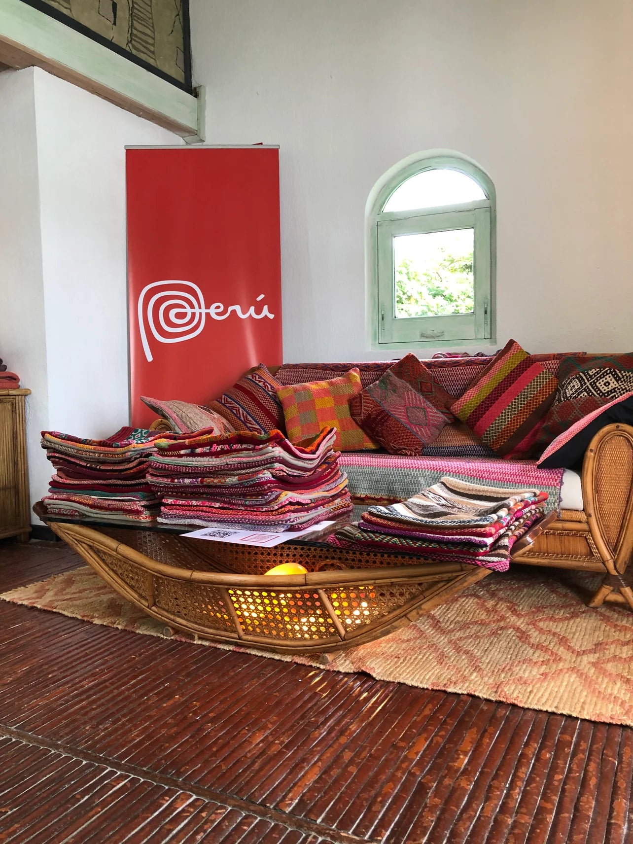 Peruvian handwoven wool cushion covers, colorful Andean patterns, displayed on wooden table and boho couch
