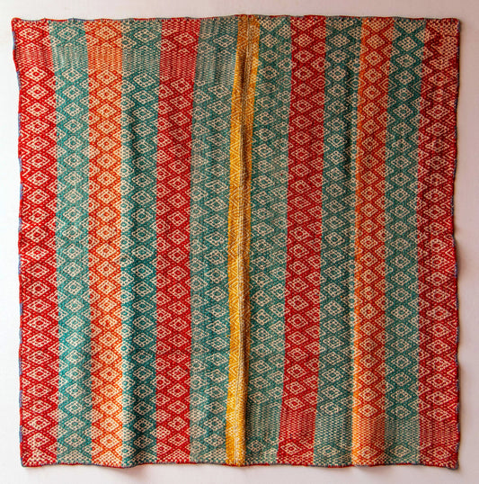 Full view of a Peruvian vintage handwoven wool rug featuring red, turquoise and yellow with Andean diamond patterns made with natural dyes.