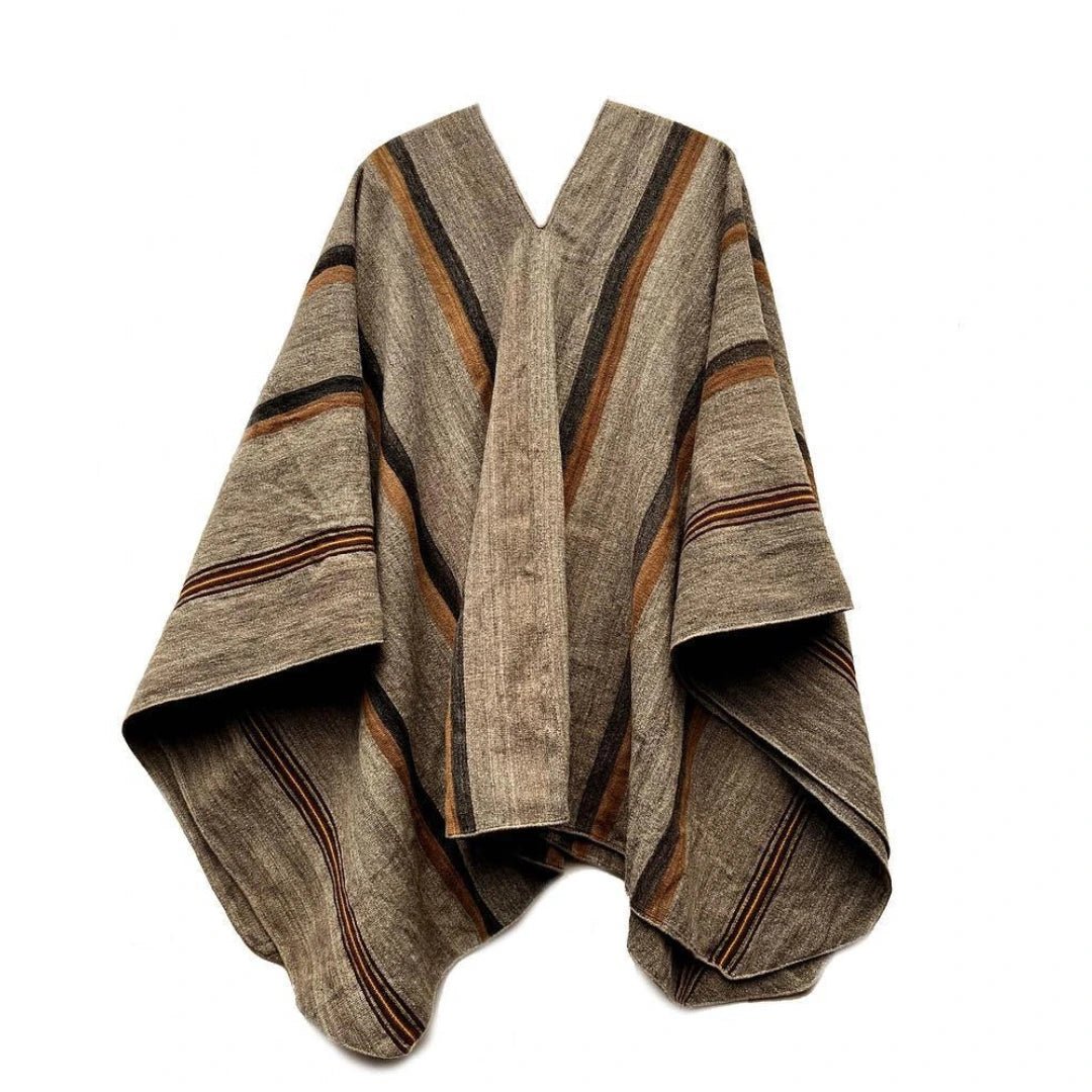 Beige Peruvian handwoven alpaca wool poncho with dark brown decorative trims on white background
