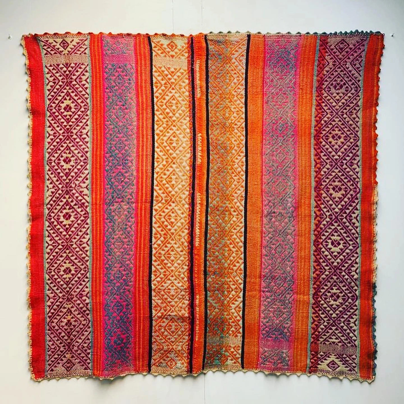 Peruvian vintage handwoven wool rug with red orange and purple geometric pattern