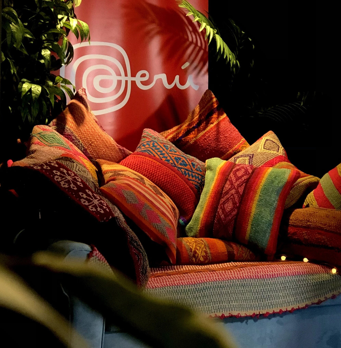 Colorful Peruvian handwoven cushions with tribal patterns on a sofa in a showroom
